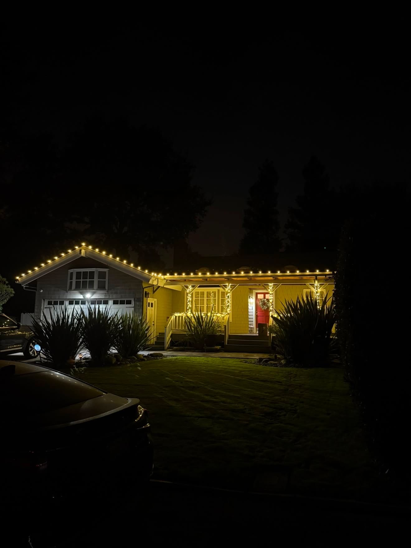 Craftsman home with warm roofline and porch lighting