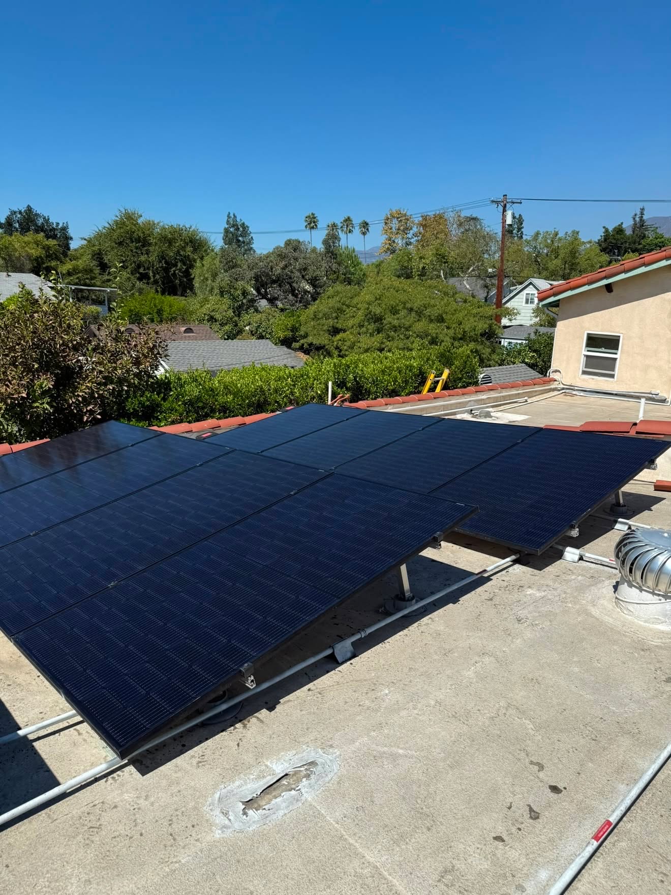 Cleaned solar array on a flat roof under clear skies