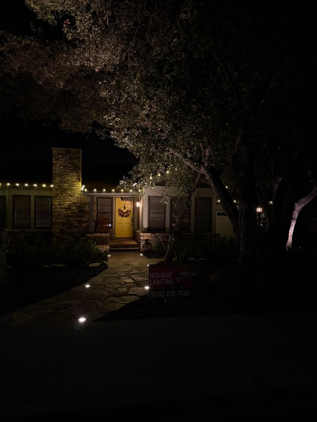Warm white roofline lights and pathway lighting at night