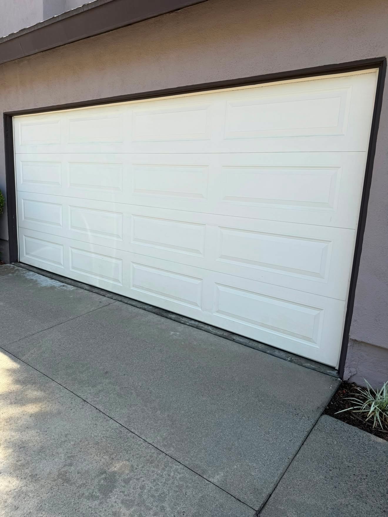 White garage door and driveway washed clean