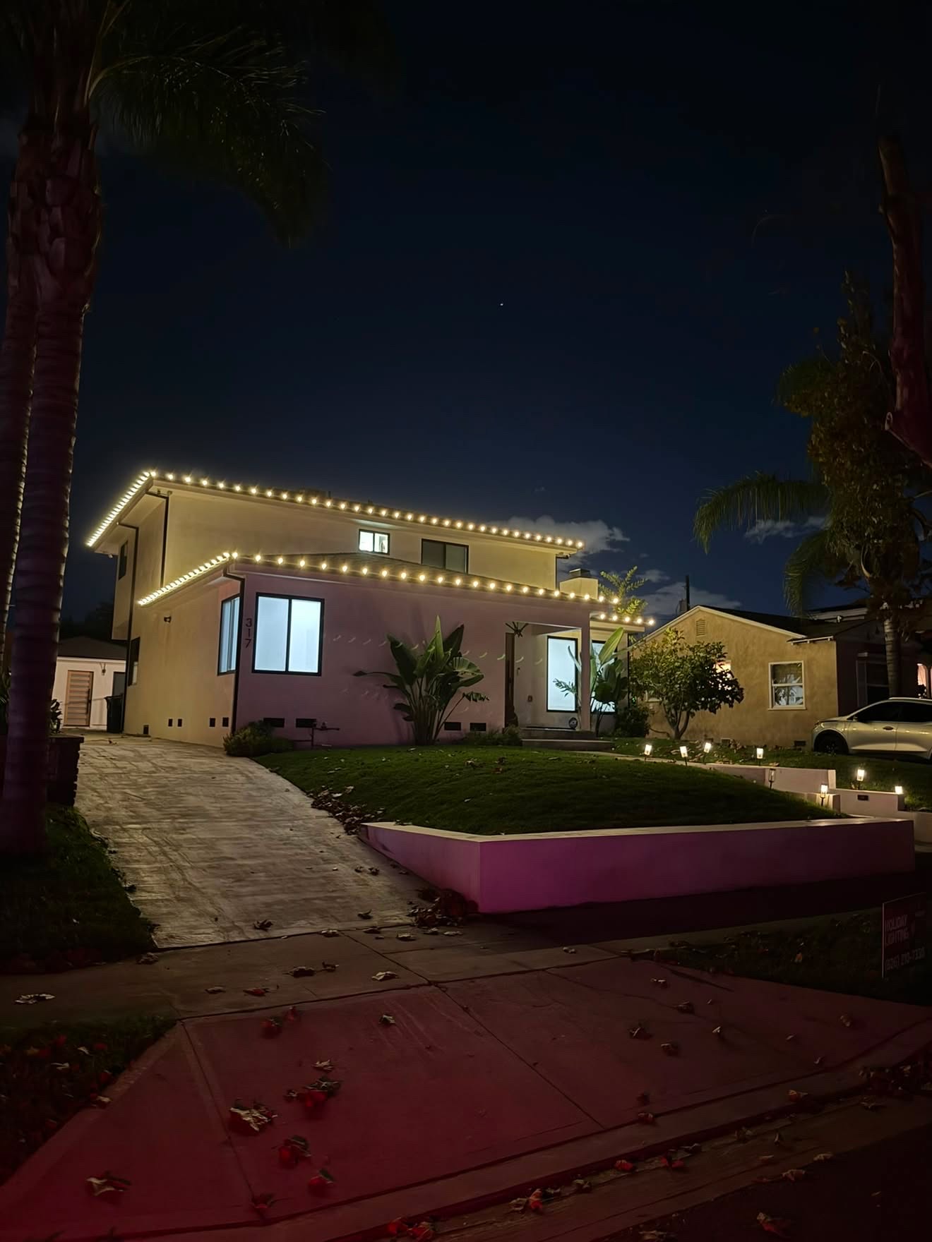 Two-story home with crisp warm white roofline lighting