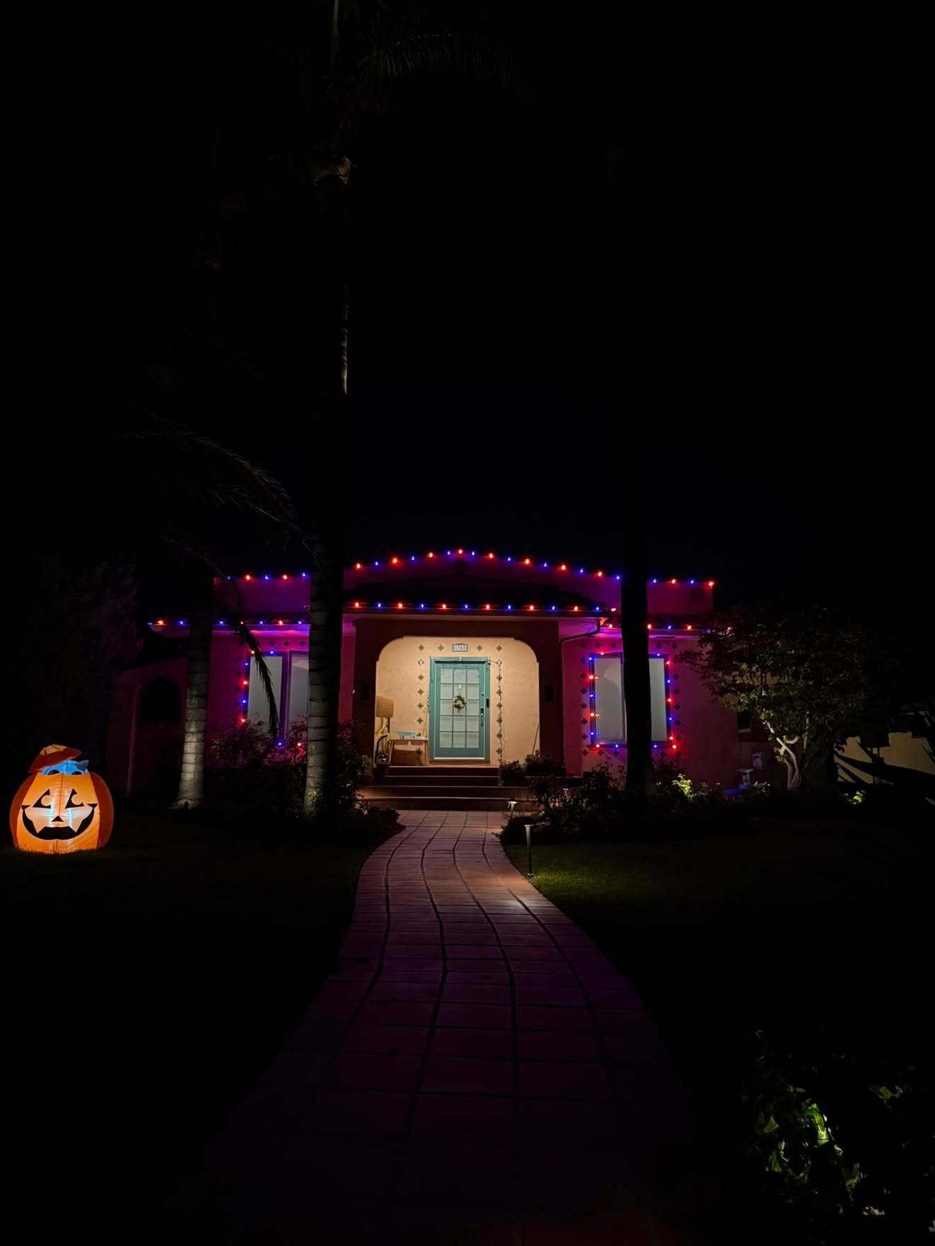 Spanish home with orange and purple Halloween lights